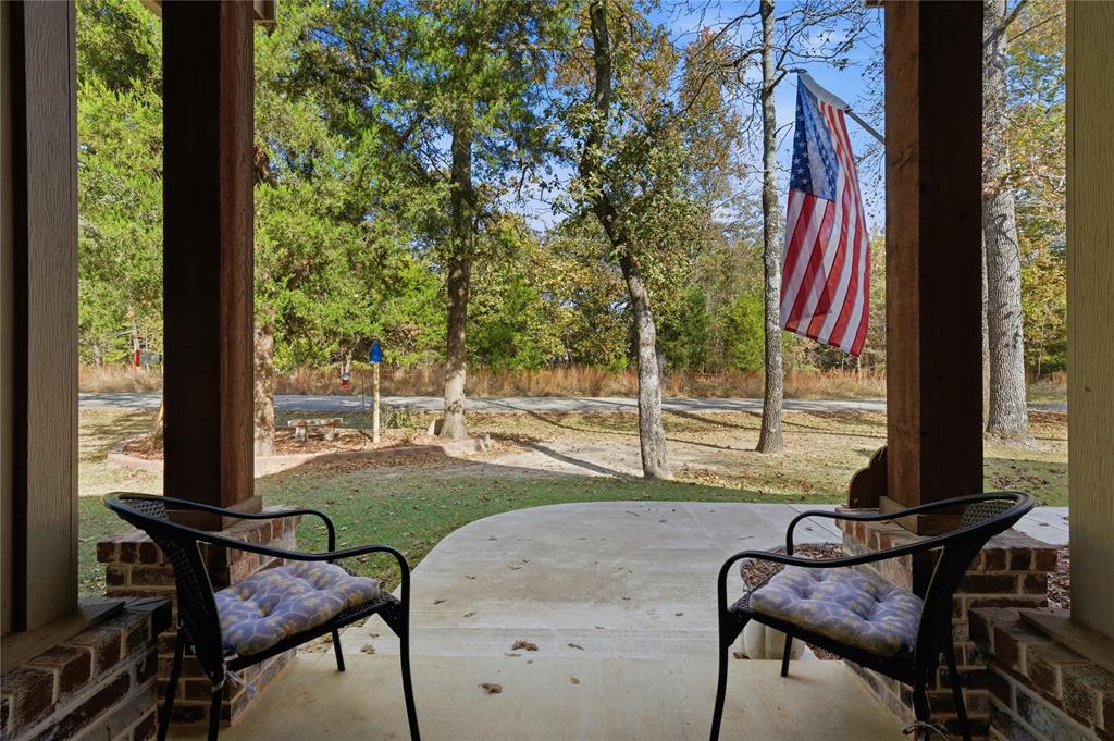 7222 Neches Street Athens, TX 75752 - Photo 21 of 27 a view of a patio with table and chairs and wooden floor