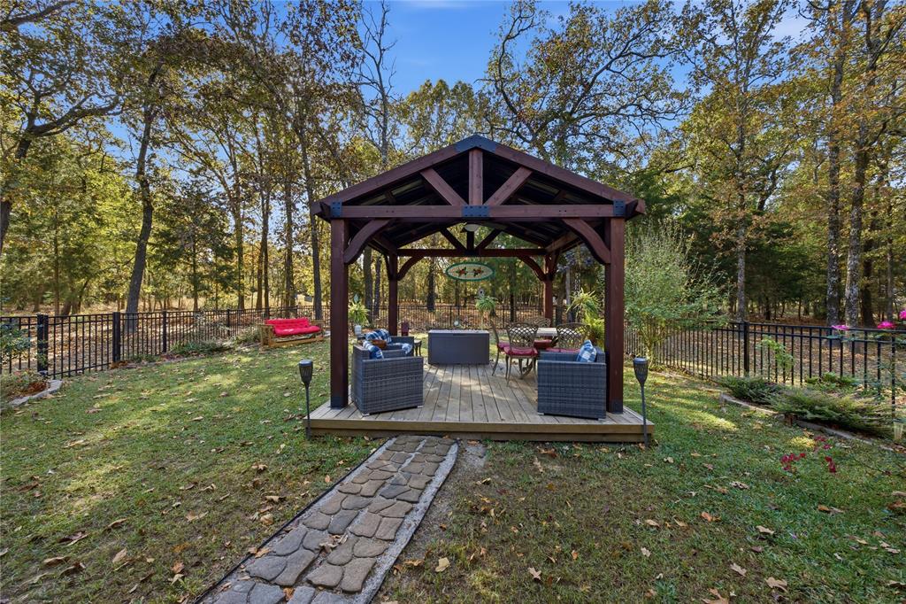 7222 Neches Street Athens, TX 75752 - Photo 22 of 27 a view of a deck with a backyard