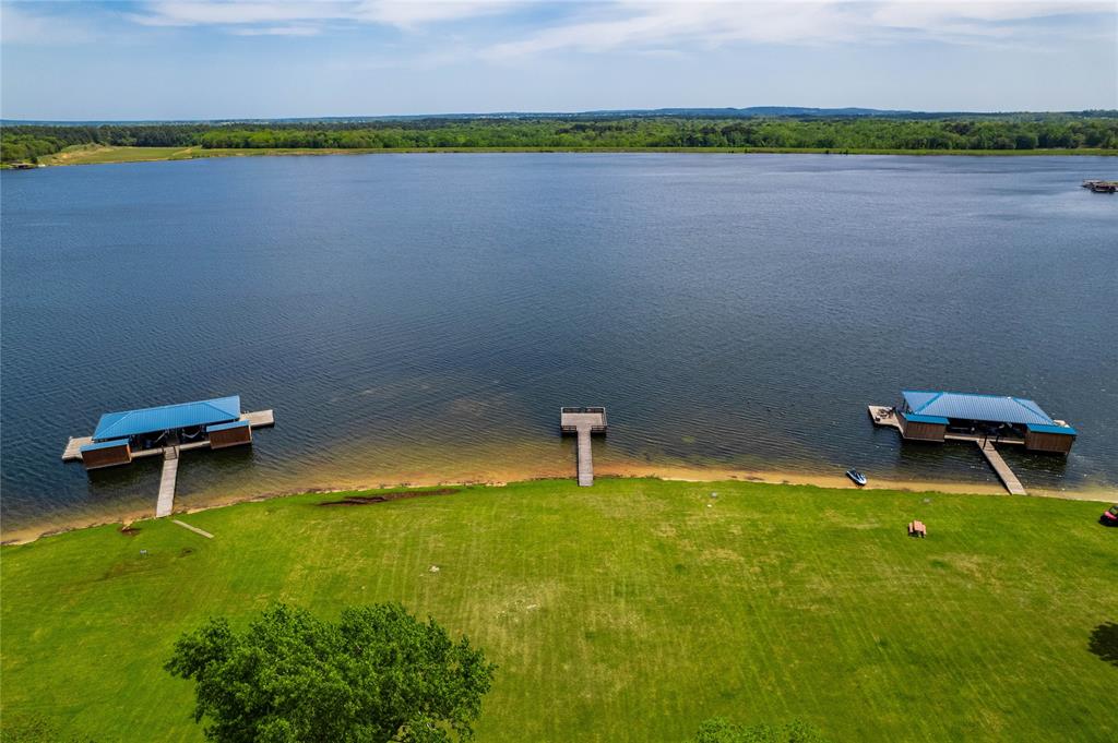 7222 Neches Street Athens, TX 75752 - Photo 25 of 27 a small pool with a bench and trees in the background