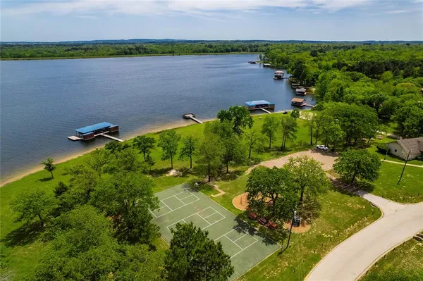 a aerial view of a house with a yard and lake view