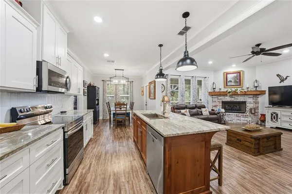 a kitchen with sink a stove and cabinets