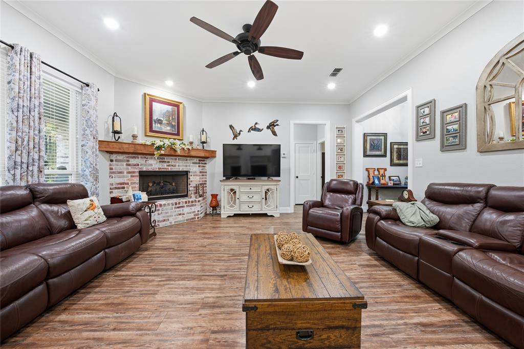 7222 Neches Street Athens, TX 75752 - Photo 6 of 27 a living room with furniture fireplace and a flat screen tv