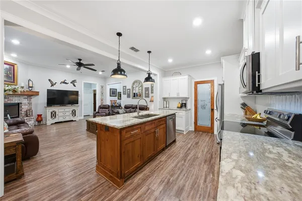 a kitchen with stainless steel appliances granite countertop a stove and refrigerator