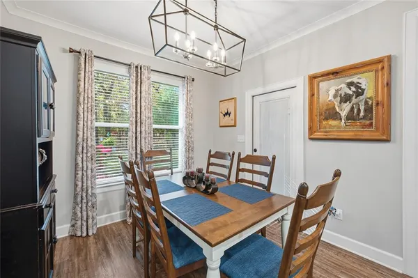 a view of a dining room with furniture wooden floor and a chandelier