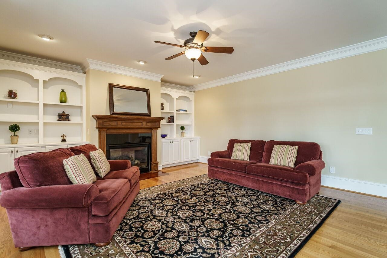 5327 Landguard Drive Raleigh, NC 27613 - Photo 15 of 45 Spacious living room with gas burning fireplace, built in cabinets and shelving and open view to the screened porch! Living Room