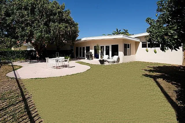 a view of a house with swimming pool and sitting area