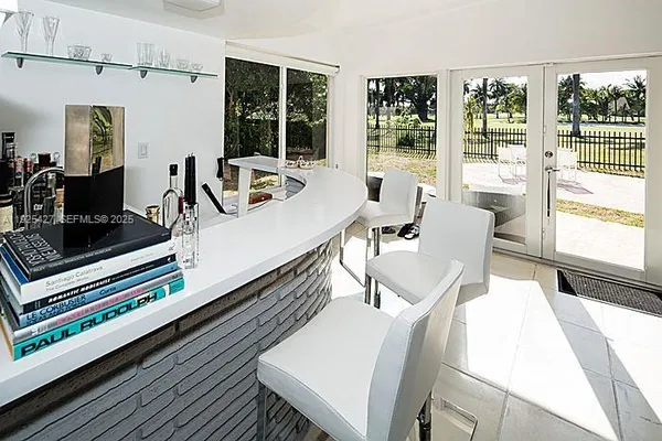 a dining room with wooden floor and large windows
