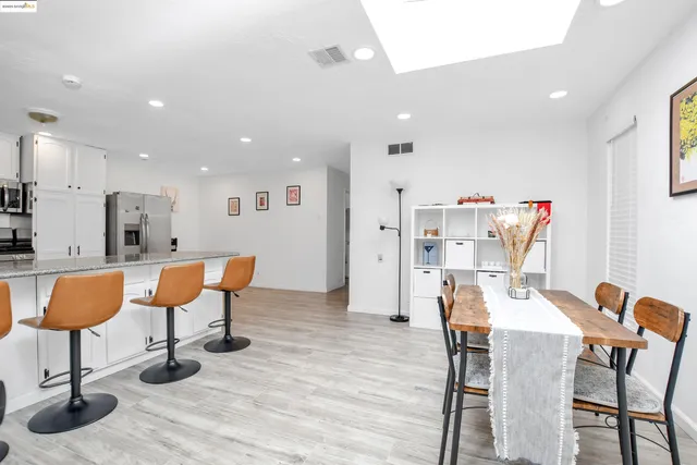 a dining room with furniture and wooden floor