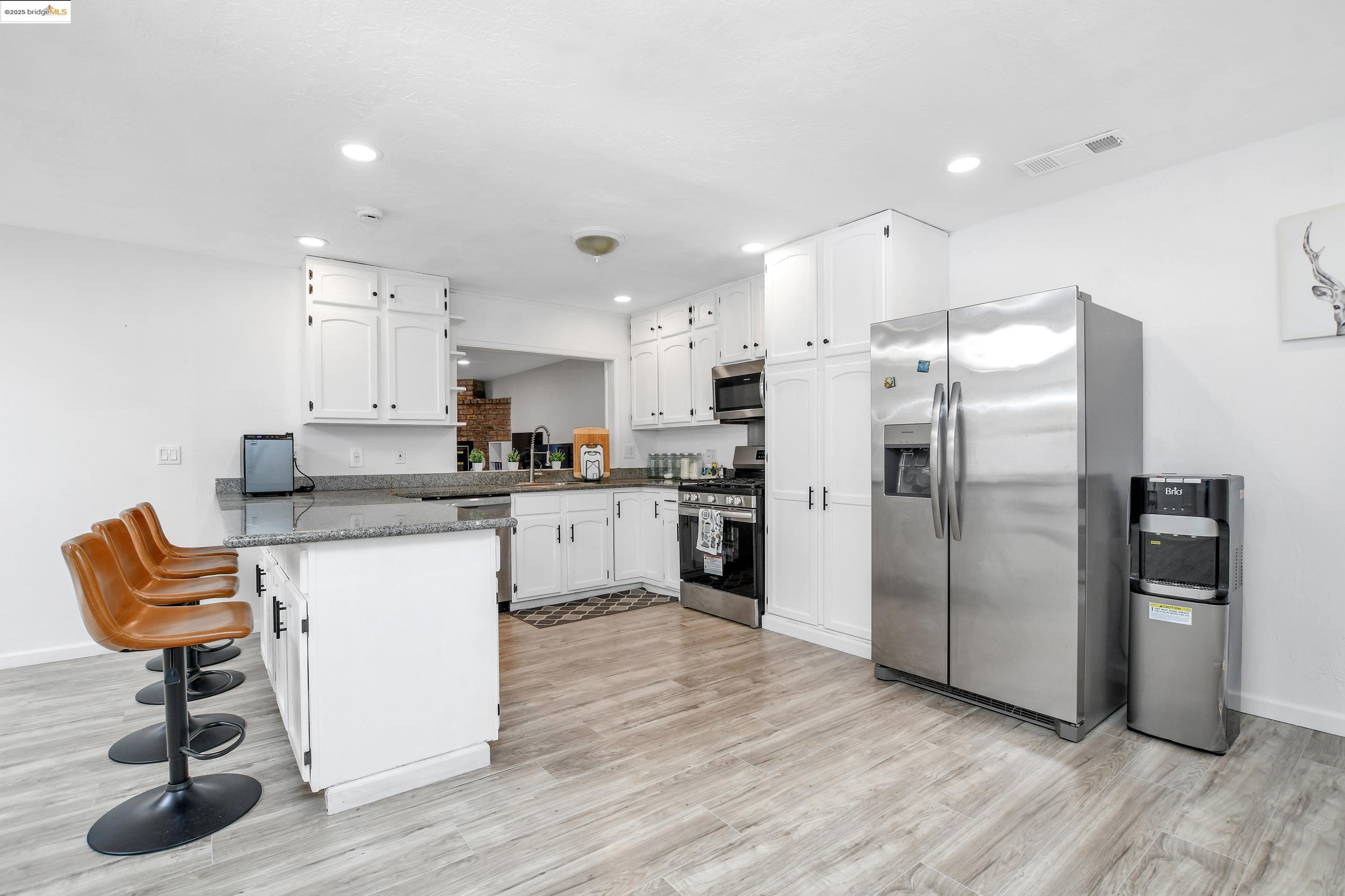 185 Evening Star Court Milpitas, CA 95035 - Photo 20 of 33 a kitchen with granite countertop a refrigerator and a stove top oven