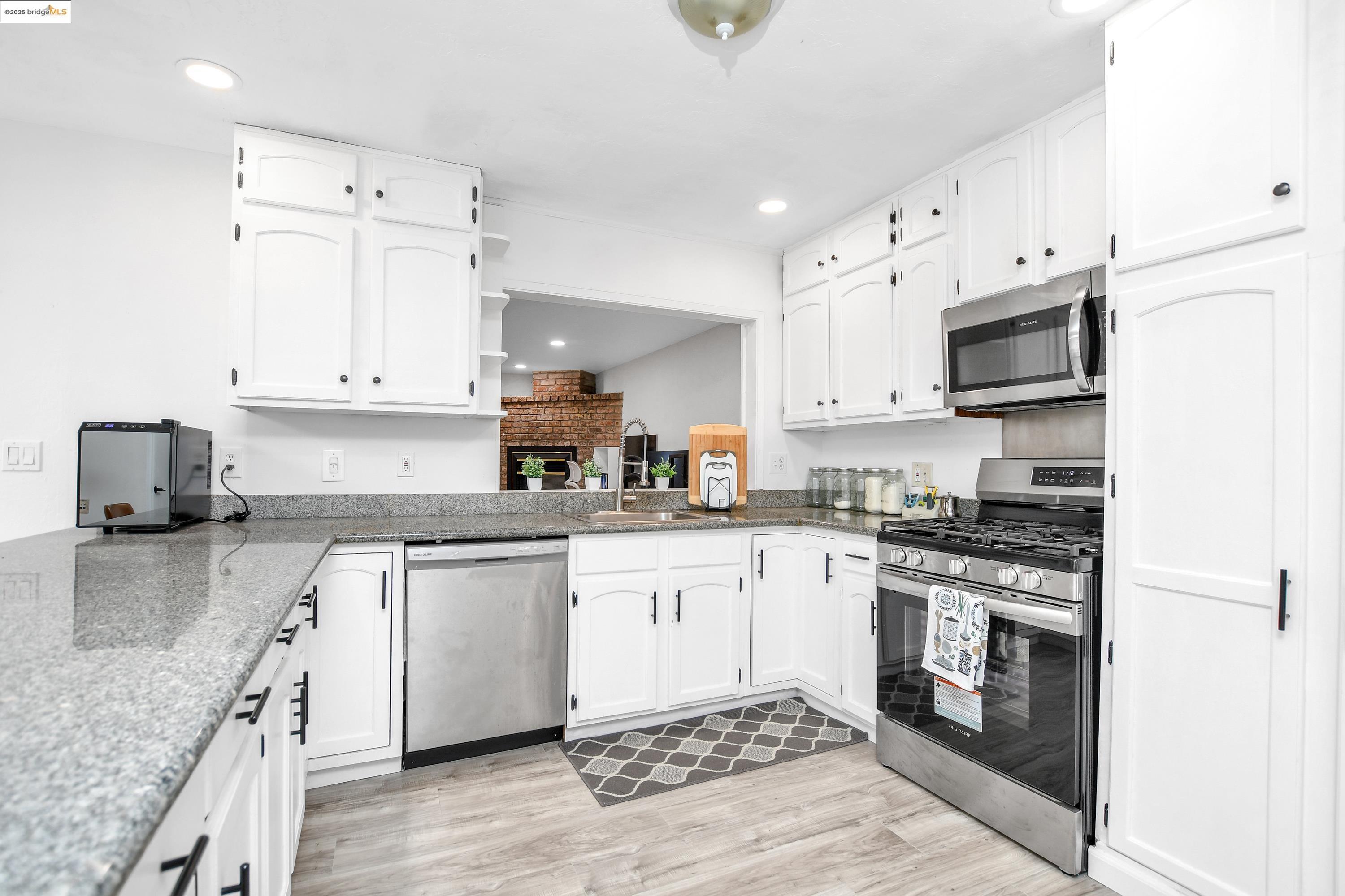 185 Evening Star Court Milpitas, CA 95035 - Photo 22 of 33 a kitchen with granite countertop a stove top oven sink and cabinets