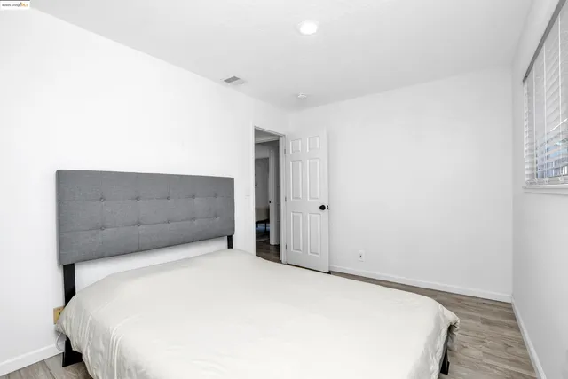 a bedroom with a bed and cabinet