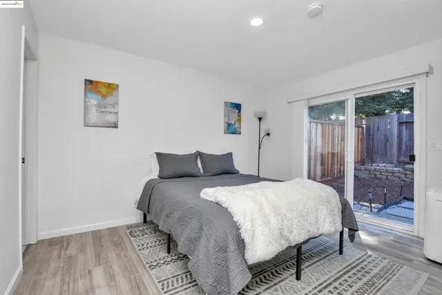 a bedroom with a bed and a painting on the wall