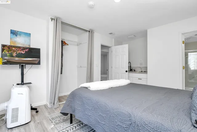 a bedroom with a bed and a mirror