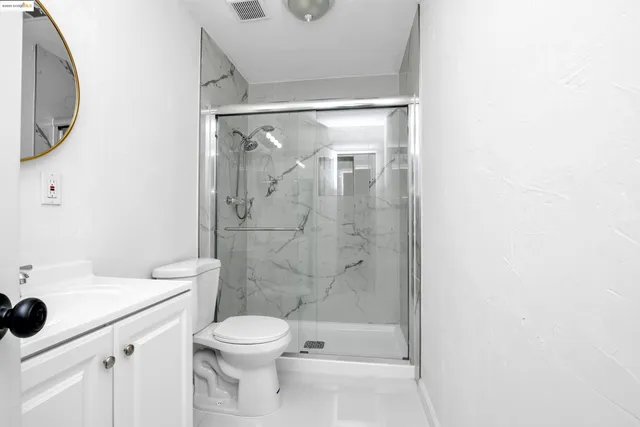a bathroom with a toilet a sink and a shower