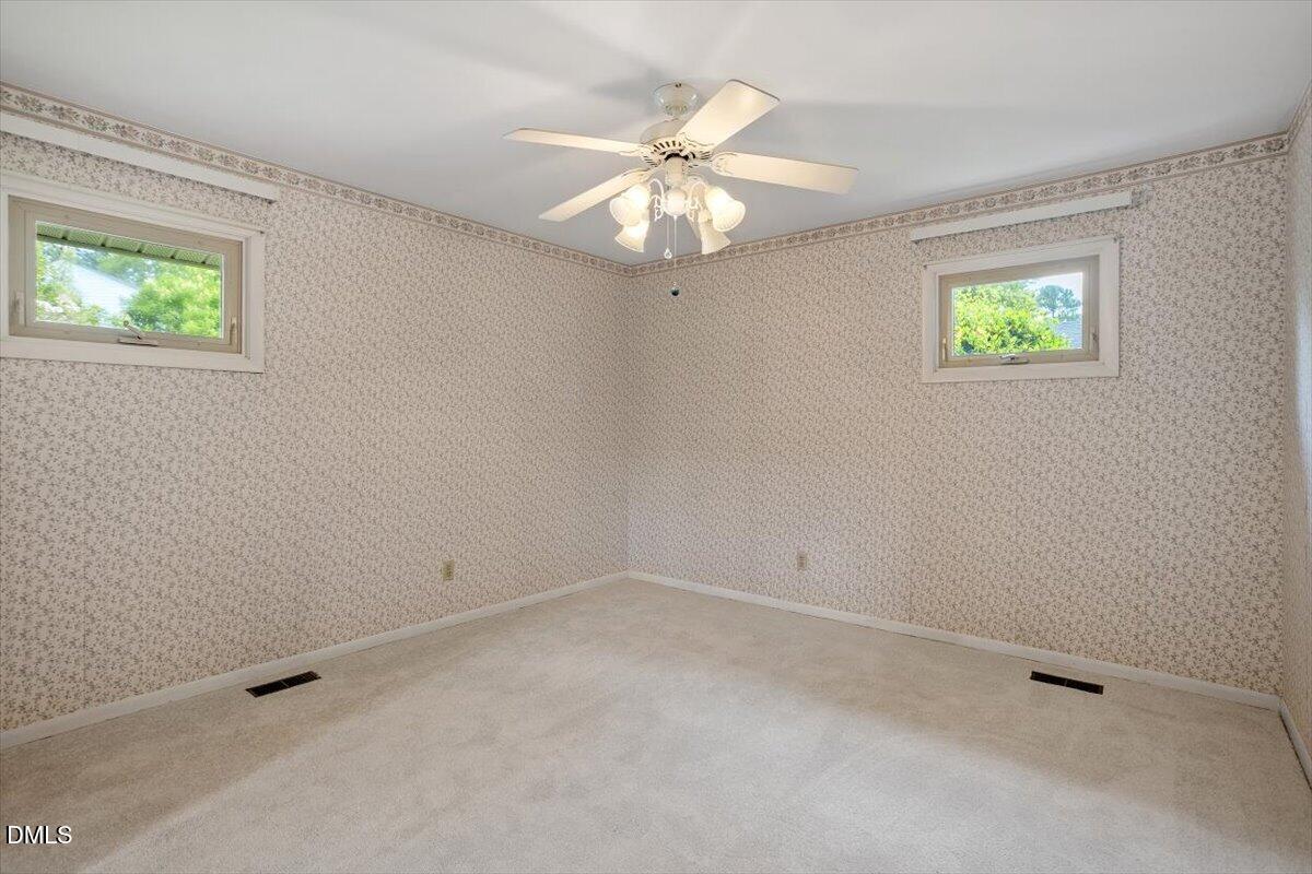 3804 Bland Road Raleigh, NC 27609 - Photo 24 of 34 an empty room with a window and a ceiling fan
