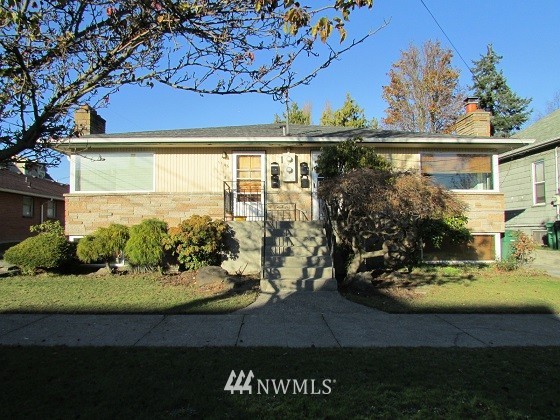 1144 Northwest 57th Street Seattle, WA 98107 - Photo 1 of 4 a view of a house with a yard
