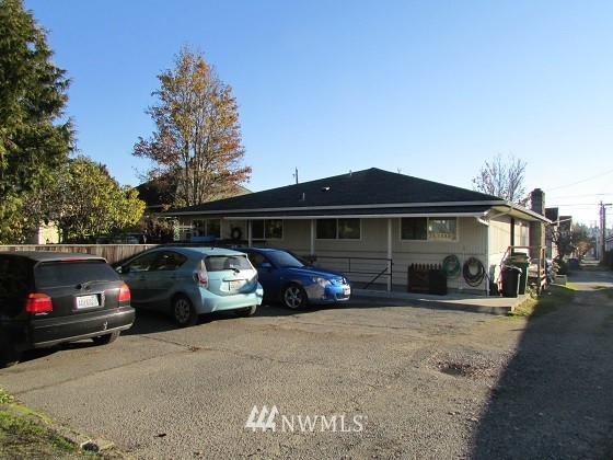 1144 Northwest 57th Street Seattle, WA 98107 - Photo 2 of 4 a view of a car parked in front of a house