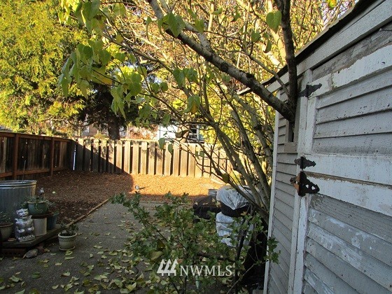 1144 Northwest 57th Street Seattle, WA 98107 - Photo 3 of 4 a view of a yard with wooden fence