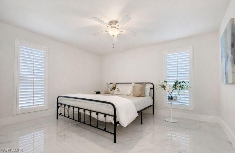 16 Knights Bridge Road Naples, FL 34112 - Photo 13 of 18 Bedroom with marble tiled floors and ceiling fan