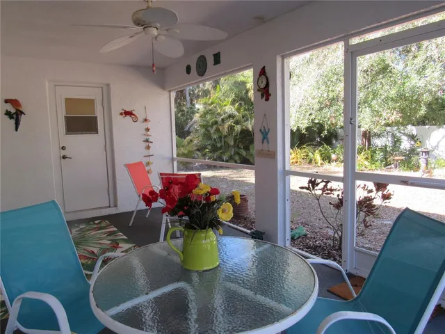 a dining room with furniture a chandelier and wooden floor