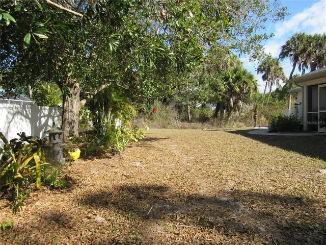 a view of dirt yard with a tree