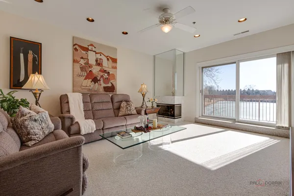 a living room with furniture flowerpot and a flat screen tv