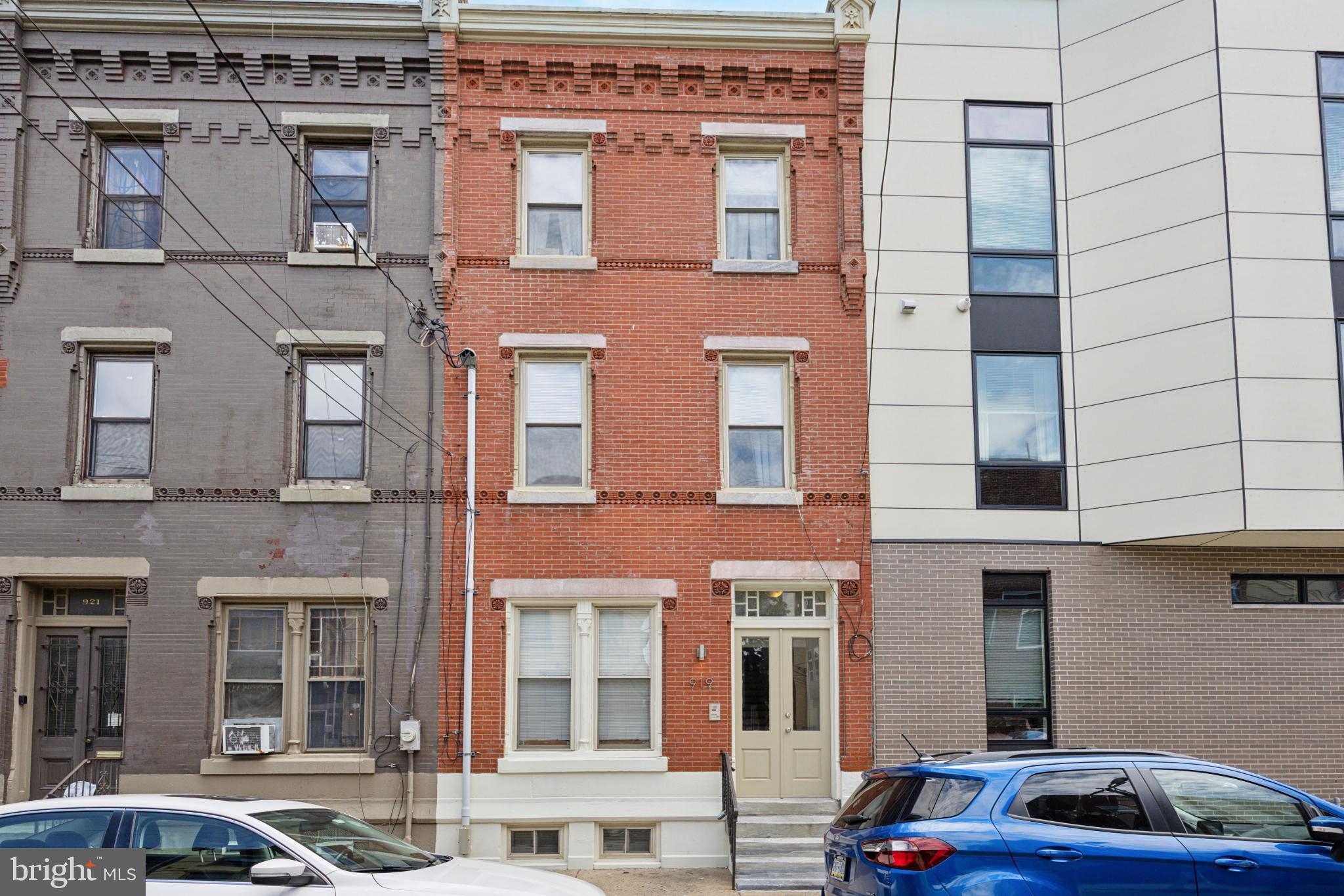 a couple of cars parked in front of a building