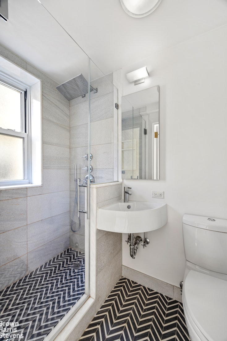 433 East 51st Street, Unit 9A Manhattan, NY 10022 - Photo 10 of 19 a bathroom with a sink toilet and shower