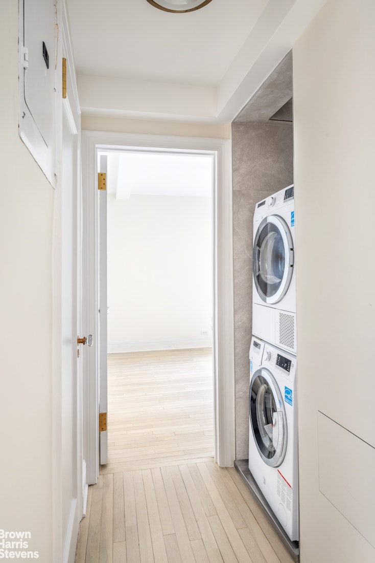 433 East 51st Street, Unit 9A Manhattan, NY 10022 - Photo 11 of 19 a utility room with dryer and washer