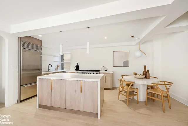 a kitchen with a stove a table and chairs in it