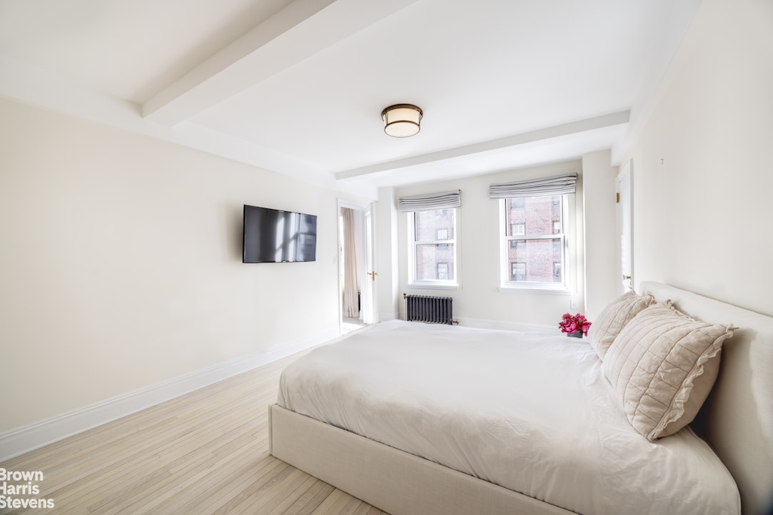 433 East 51st Street, Unit 9A Manhattan, NY 10022 - Photo 7 of 19 a bedroom with a bed and a window