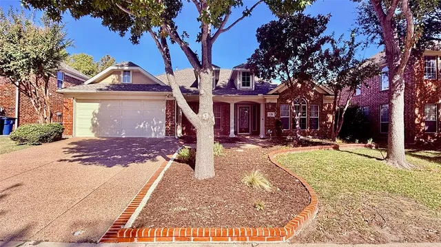 a front view of a house with a yard covered with snow