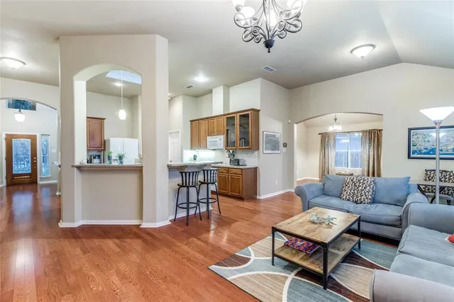 a living room with furniture and a view of kitchen