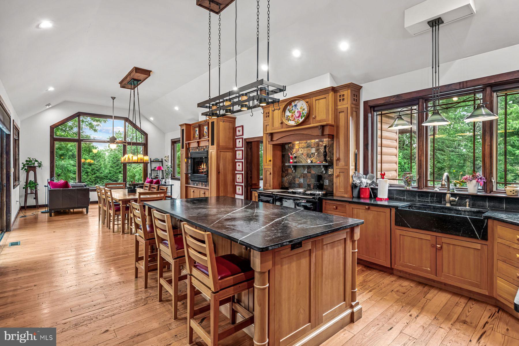 1408 Rene Road Villanova, PA 19085 - Photo 21 of 66 a kitchen with stainless steel appliances granite countertop a stove top oven a dining table and chairs with wooden floor