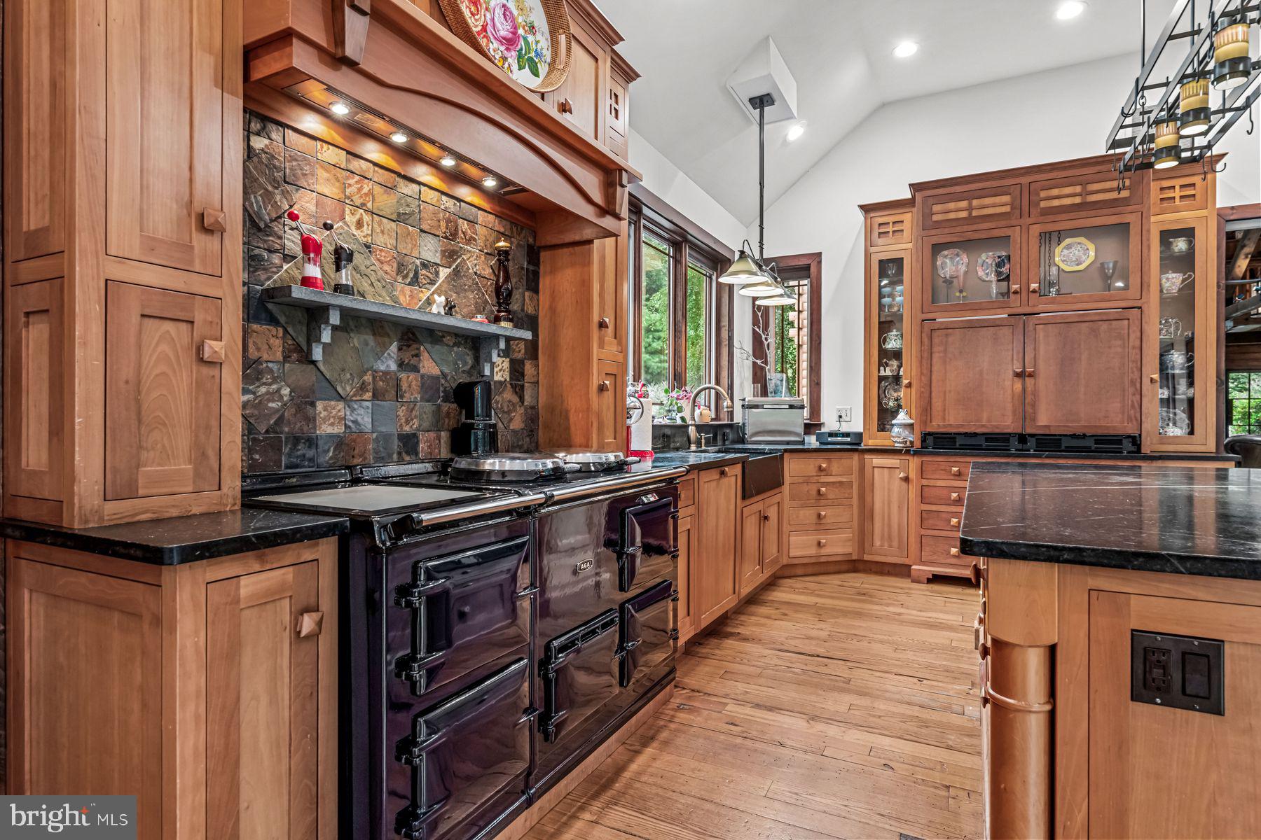 1408 Rene Road Villanova, PA 19085 - Photo 23 of 66 a kitchen with stainless steel appliances granite countertop a stove a sink and a microwave