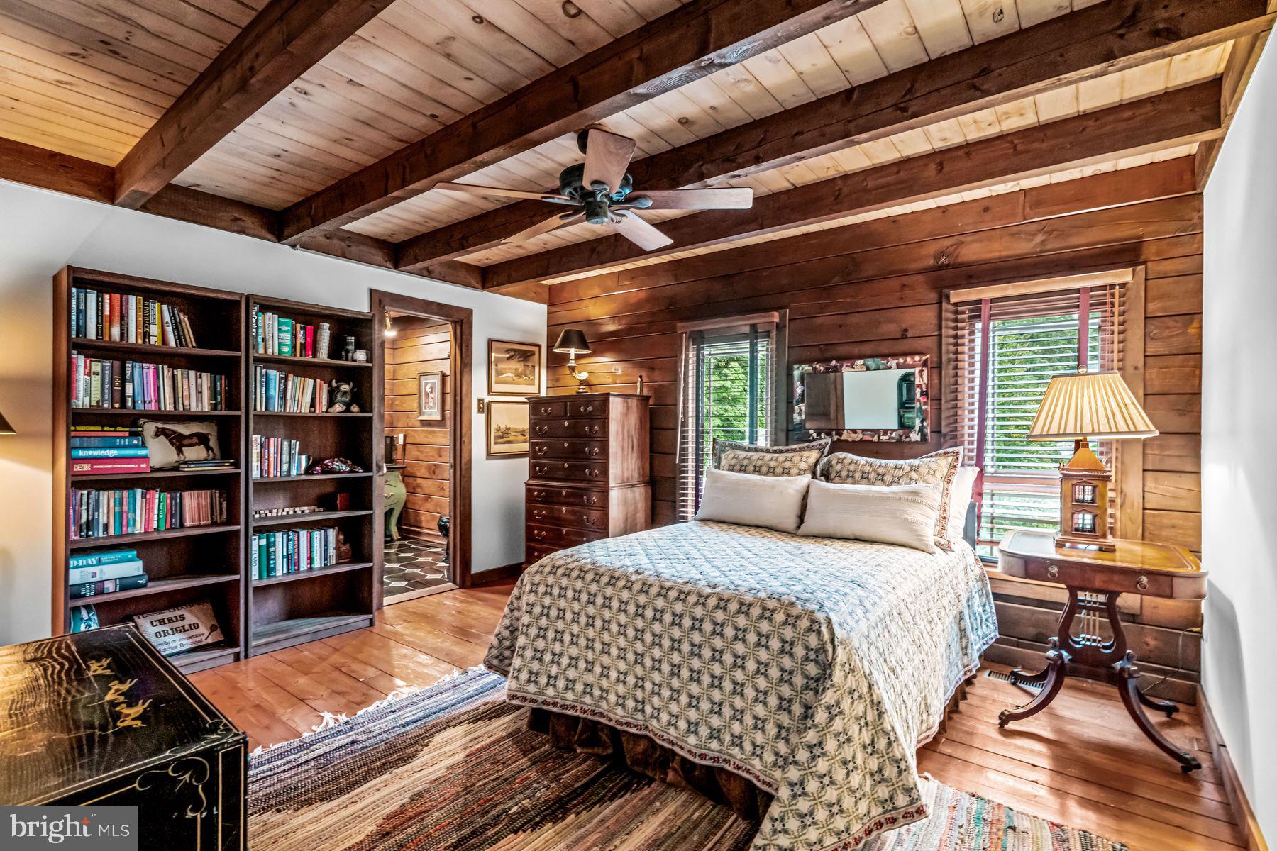1408 Rene Road Villanova, PA 19085 - Photo 43 of 66 a bedroom with a bed a table and a book shelf