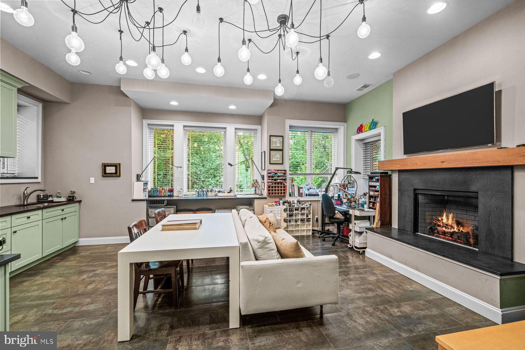 1408 Rene Road Villanova, PA 19085 - Photo 55 of 66 a living room with furniture a flat screen tv and a fireplace