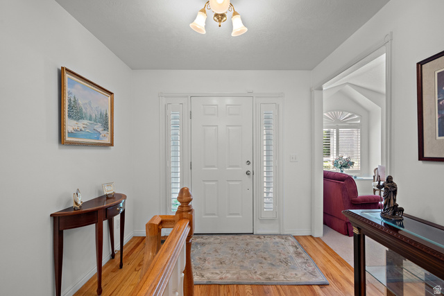 166 South Ridgeview Drive Orem, UT 84058 - Photo 4 of 38 Entryway with hardwood flooring, a paneled door, and sidelight windows with shutters