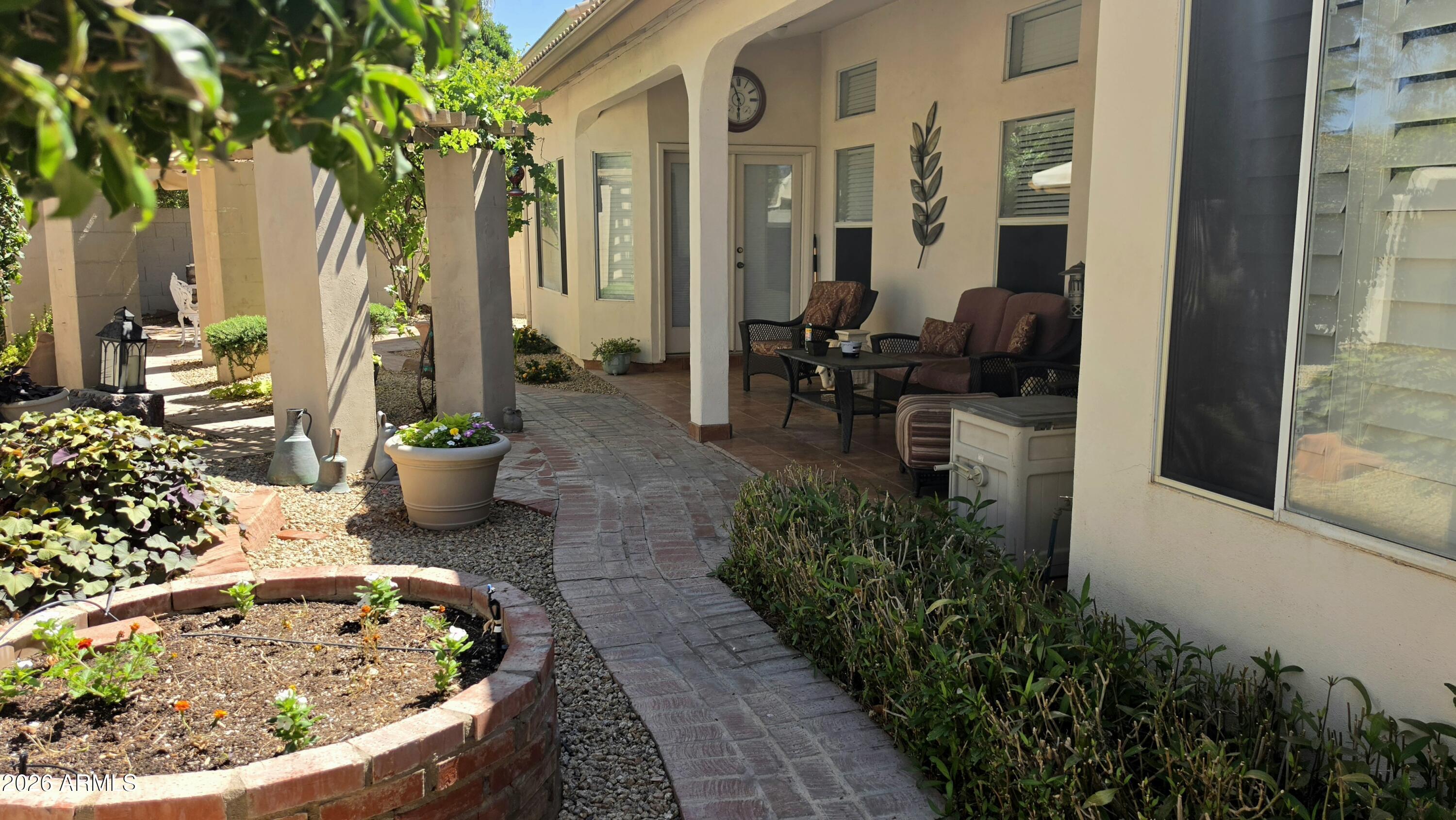 2214 East Beachcomber Drive Gilbert, AZ 85234 - Photo 26 of 45 a view of a backyard with plants and patio