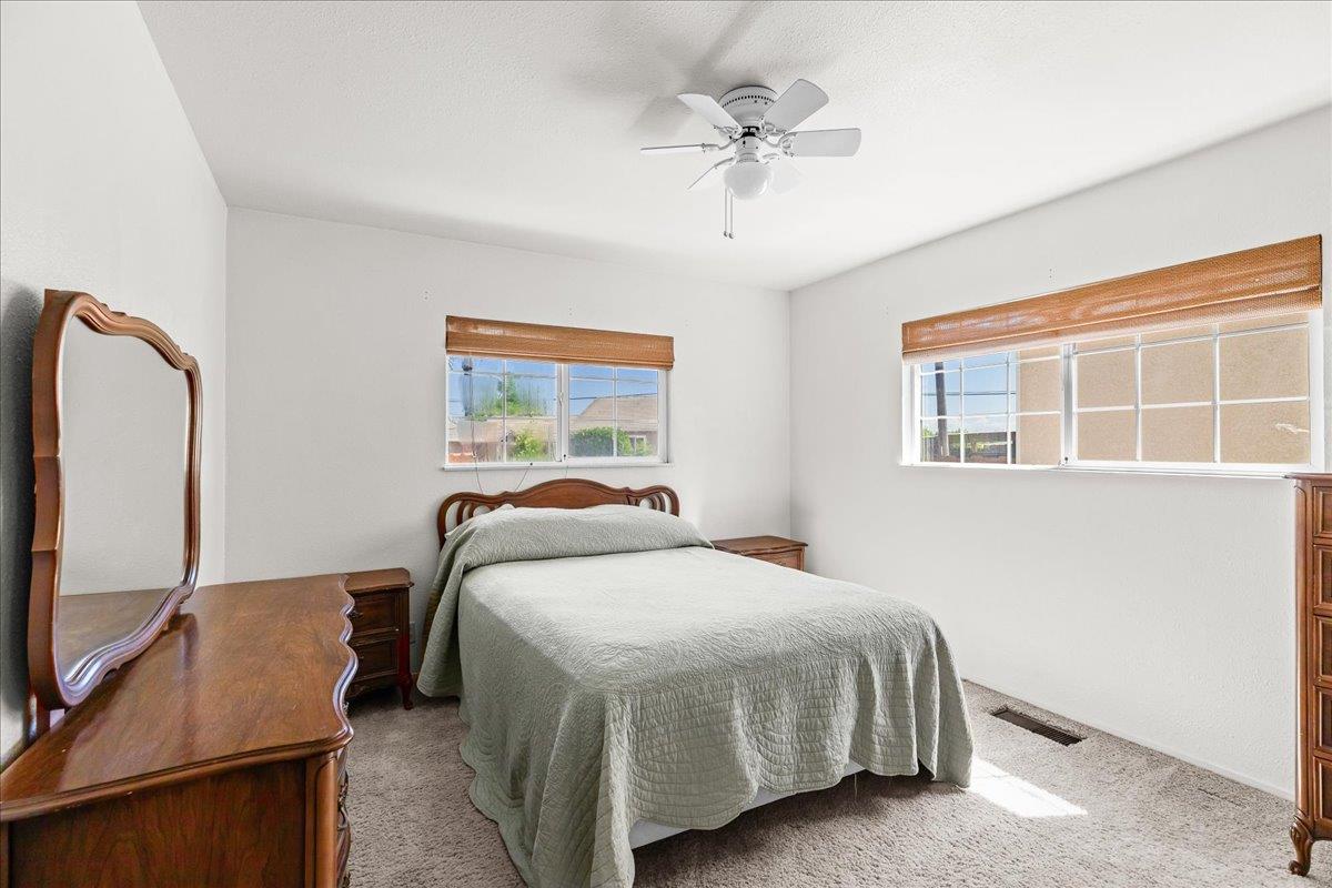 4701 Lone Tree Road Valley Home, CA 95361 - Photo 34 of 59 a bedroom with a bed dresser and wooden floor