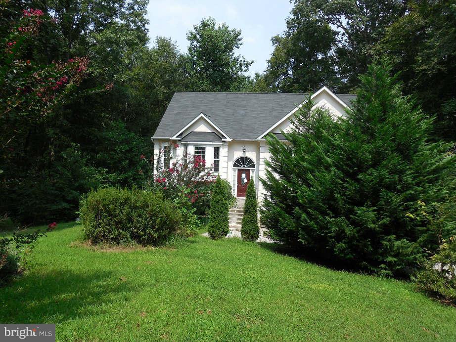 258 Cedar Ridge Drive Ruther Glen, VA 22546 - Photo 1 of 29 a front view of a house with a yard