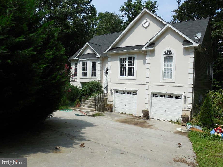 258 Cedar Ridge Drive Ruther Glen, VA 22546 - Photo 2 of 29 a view of a house with a yard and large tree