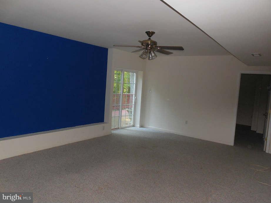 258 Cedar Ridge Drive Ruther Glen, VA 22546 - Photo 24 of 29 a view of a livingroom with a ceiling fan and window