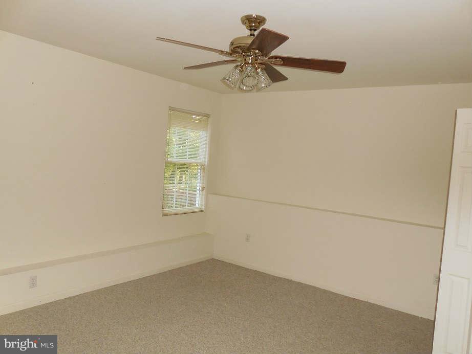 258 Cedar Ridge Drive Ruther Glen, VA 22546 - Photo 26 of 29 an empty room with a window and a fan