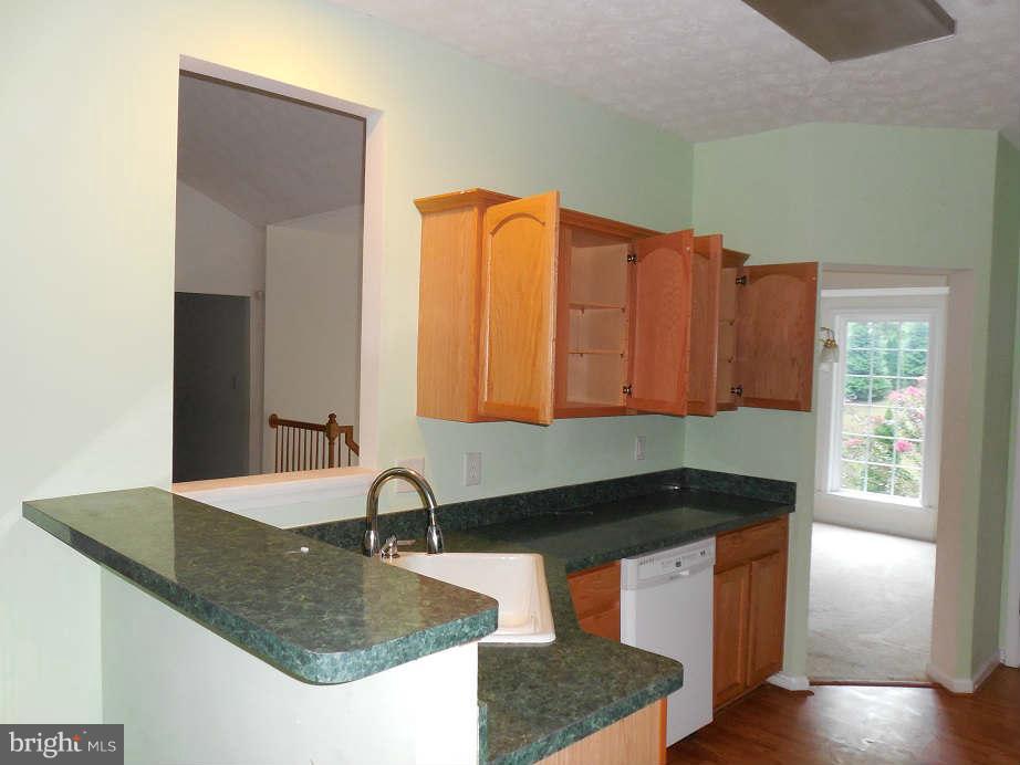 258 Cedar Ridge Drive Ruther Glen, VA 22546 - Photo 8 of 29 a kitchen with granite countertop a sink and a stove