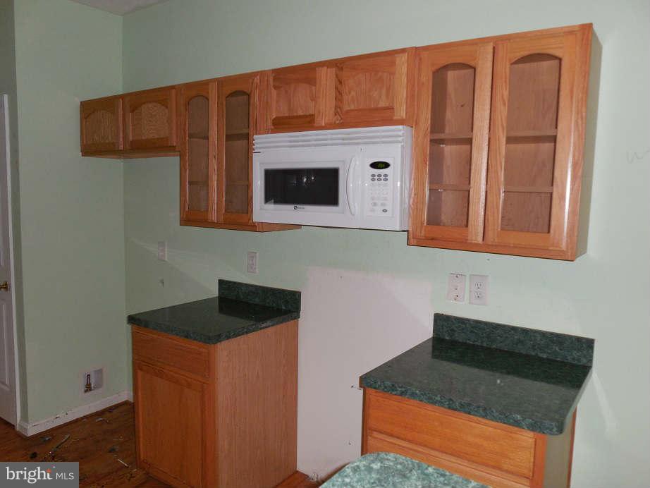 258 Cedar Ridge Drive Ruther Glen, VA 22546 - Photo 9 of 29 a kitchen with stainless steel appliances granite countertop a sink stove and cabinets