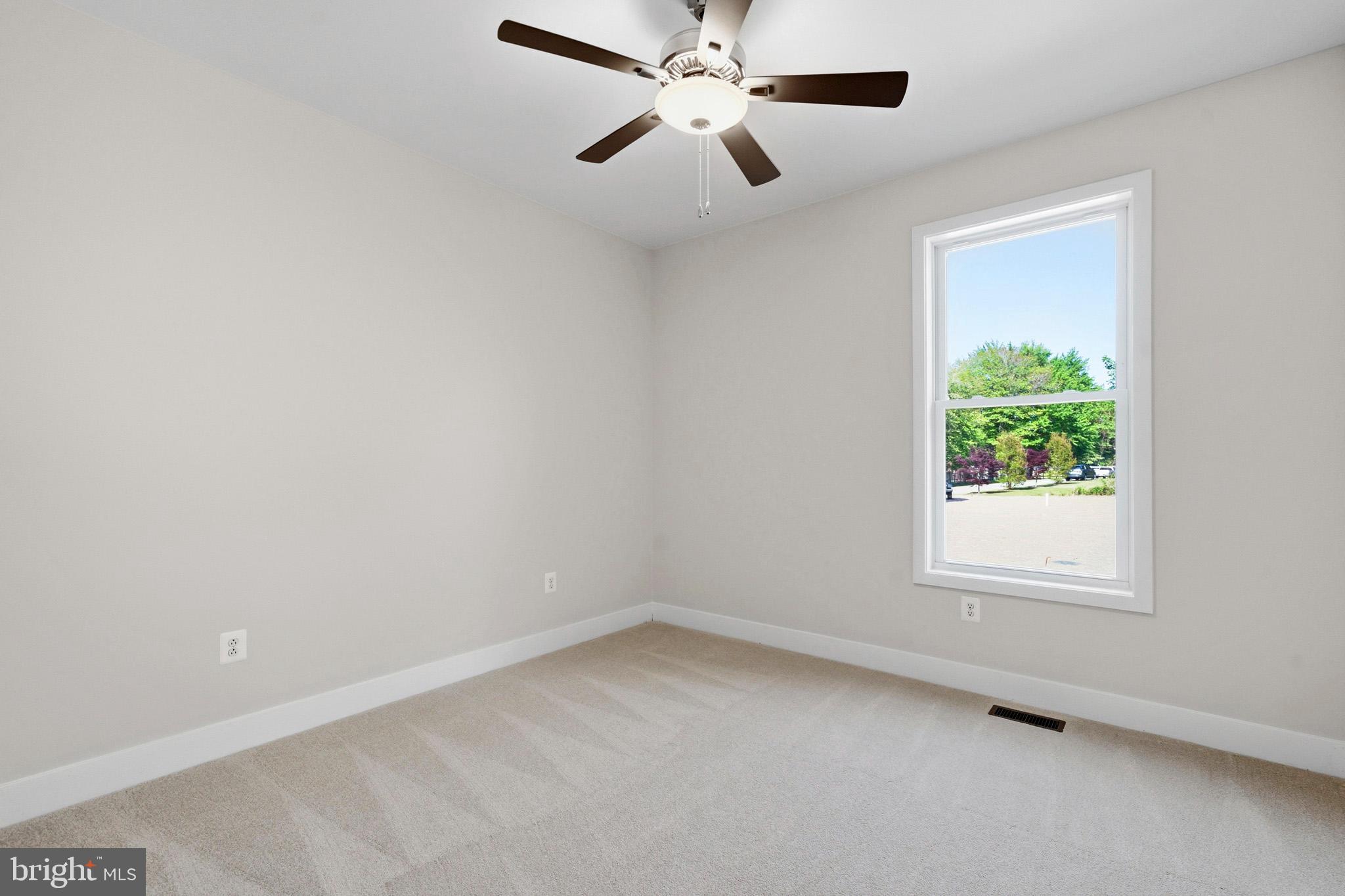 1362 Solomons Island Road Huntingtown, MD 20639 - Photo 19 of 37 an empty room with a window and a fan