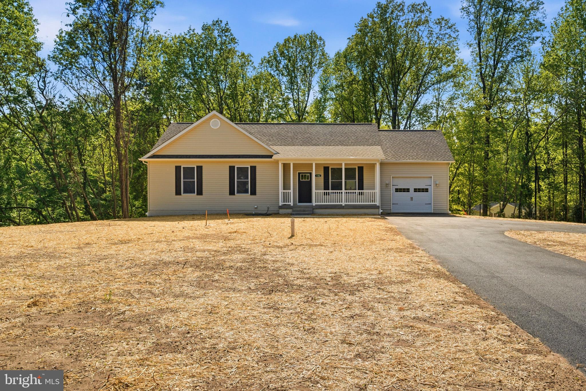 1362 Solomons Island Road Huntingtown, MD 20639 - Photo 2 of 37 a house with trees in the background