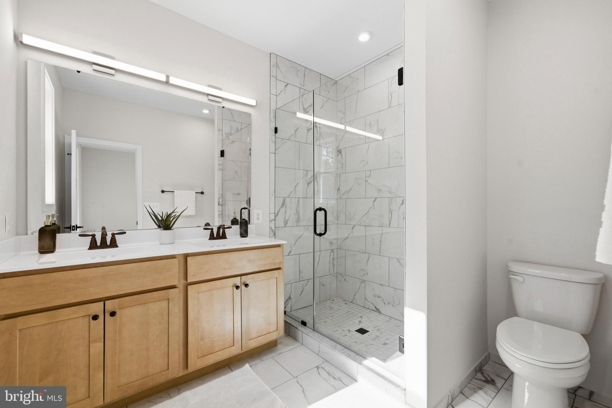 1362 Solomons Island Road Huntingtown, MD 20639 - Photo 27 of 37 a bathroom with a shower sink mirror and toilet