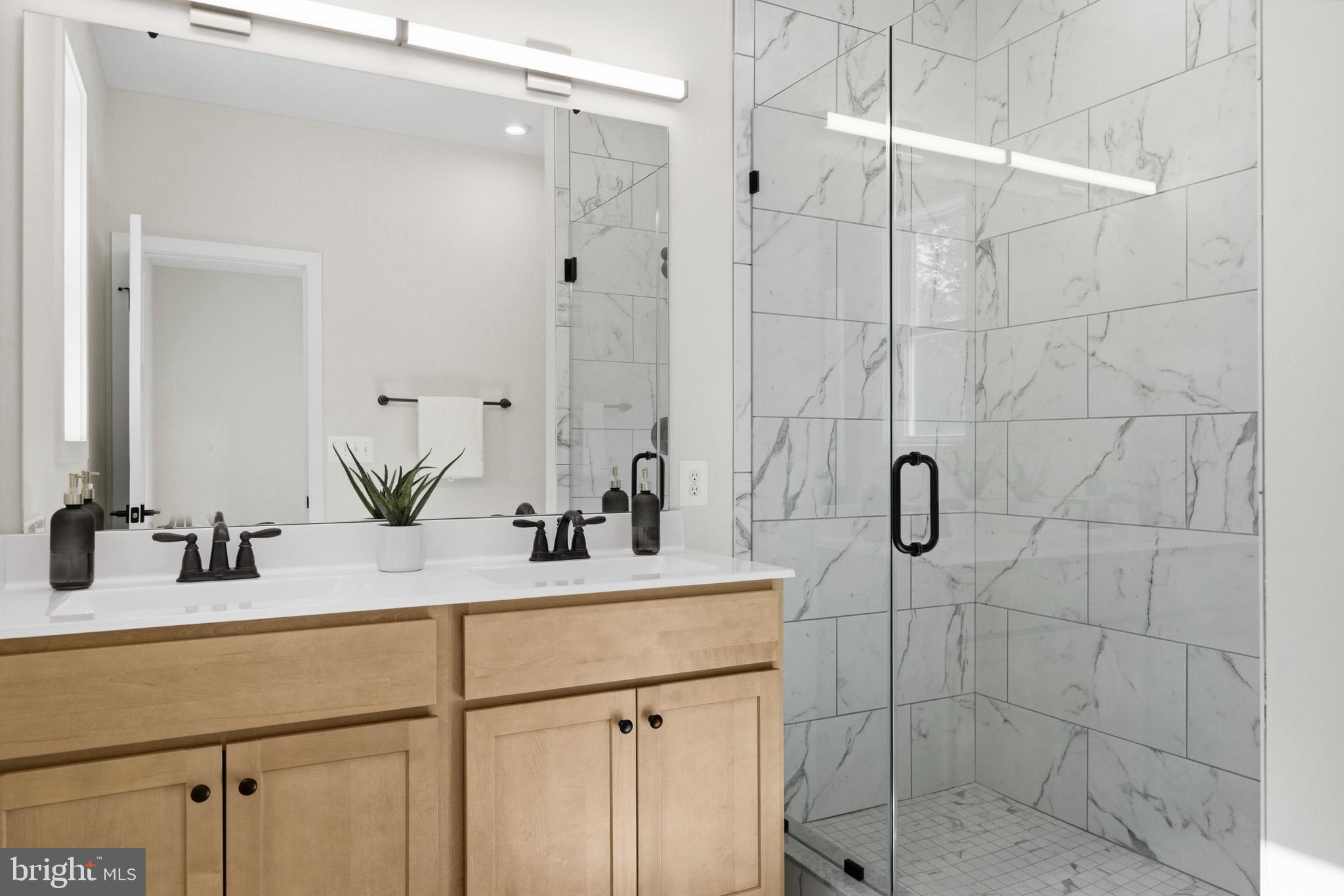 1362 Solomons Island Road Huntingtown, MD 20639 - Photo 28 of 37 a bathroom with a shower sink and mirror